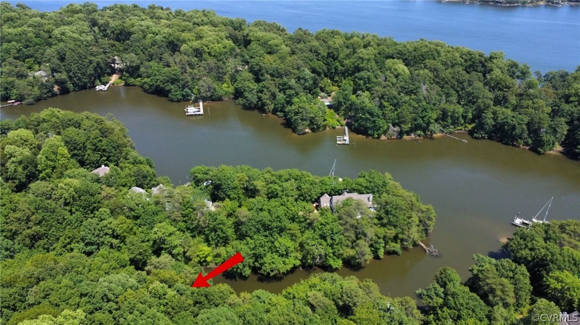 an aerial view of residential houses with outdoor space and lake view