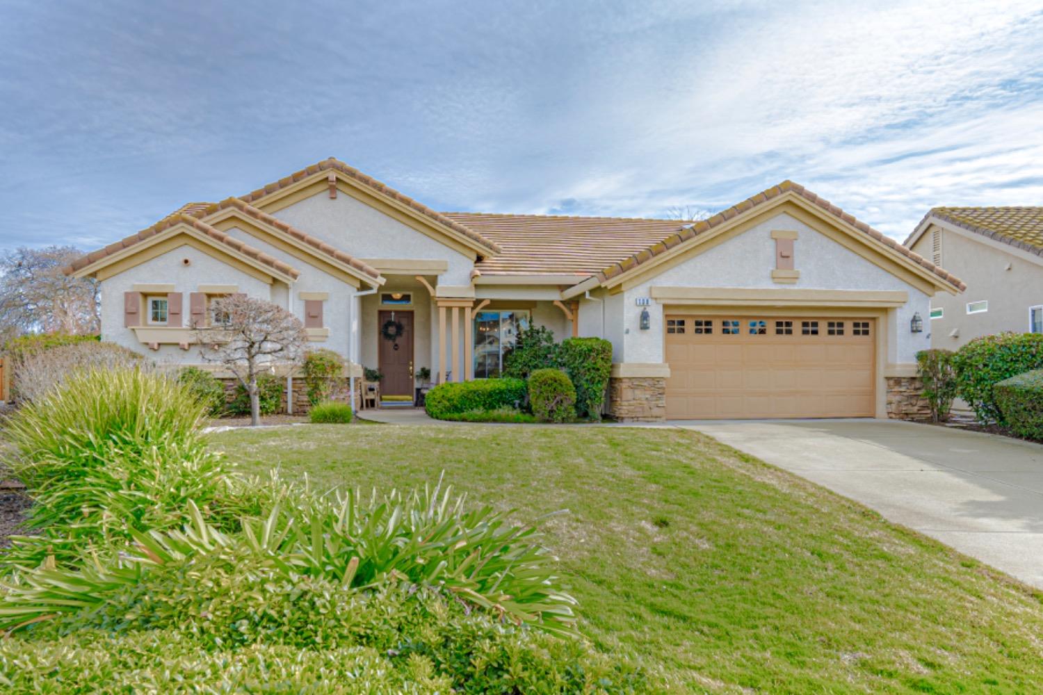 a front view of a house with a yard and garage