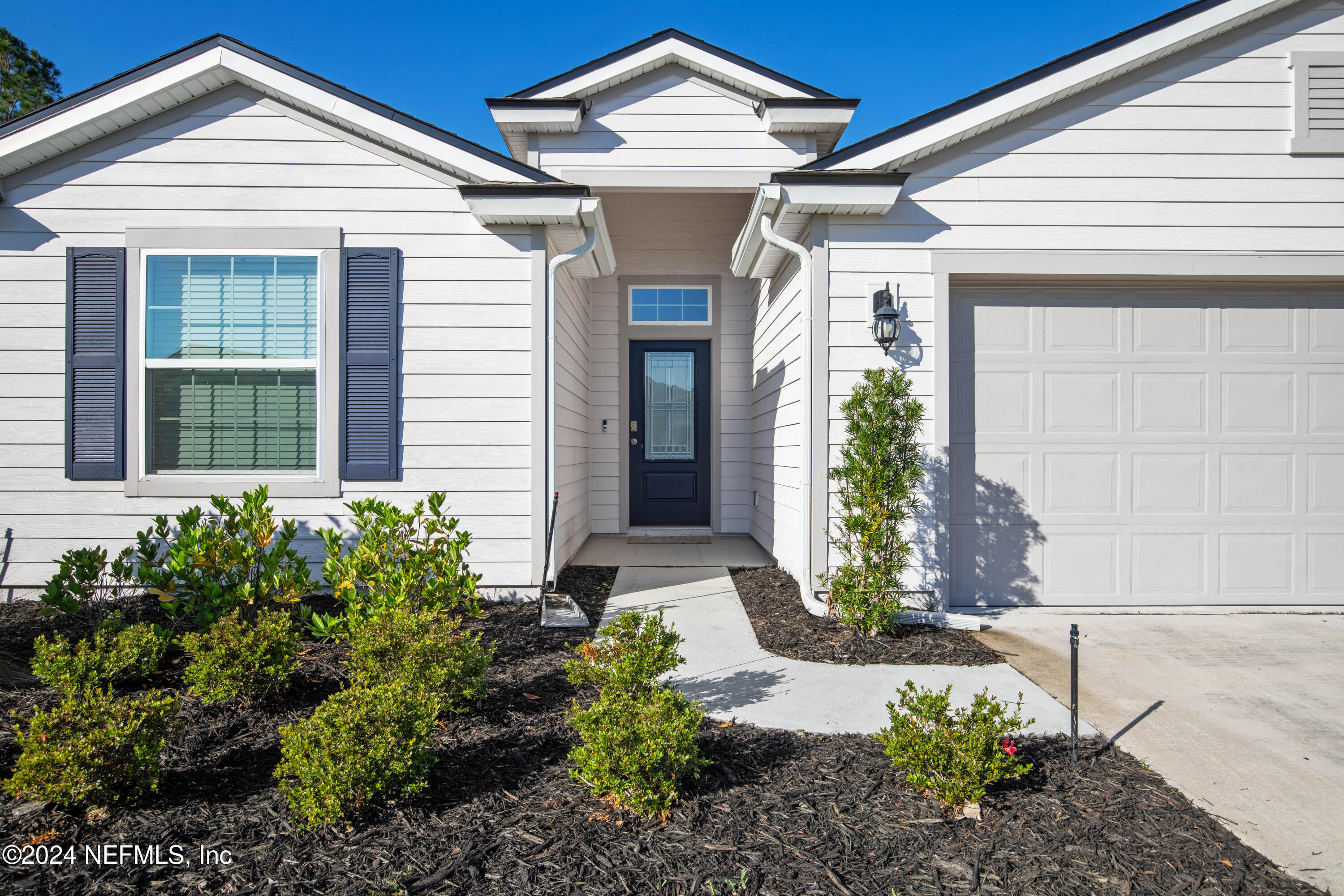 a front view of a house with garden