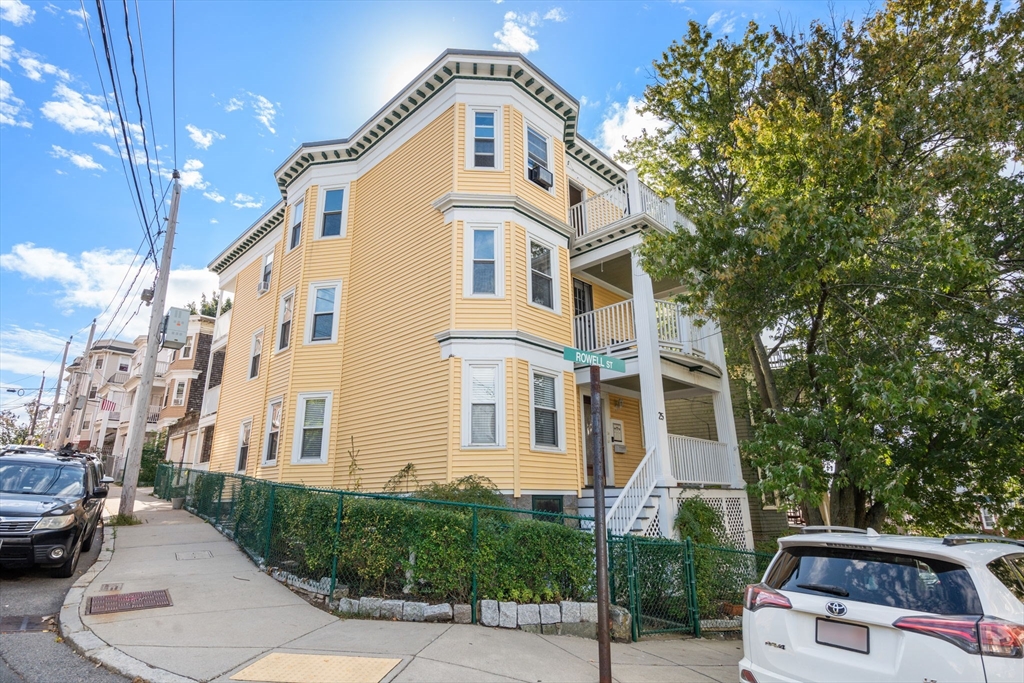 a front view of a residential apartment building with a yard