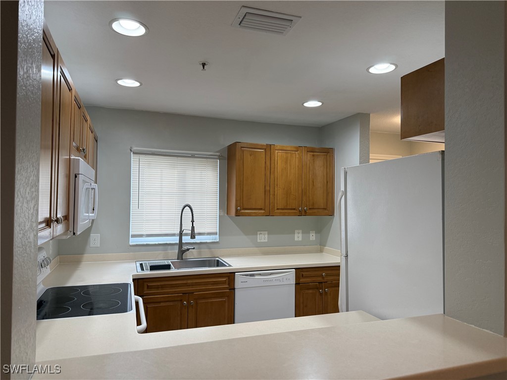 a kitchen with granite countertop stainless steel appliances and sink