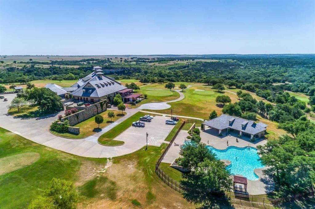 an aerial view of residential houses with outdoor space and swimming pool