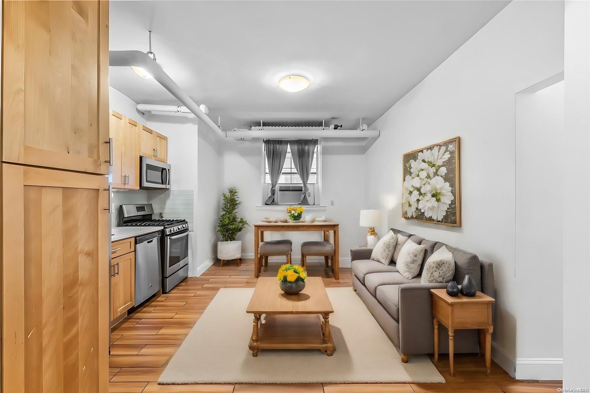 a living room with furniture a couch and kitchen view