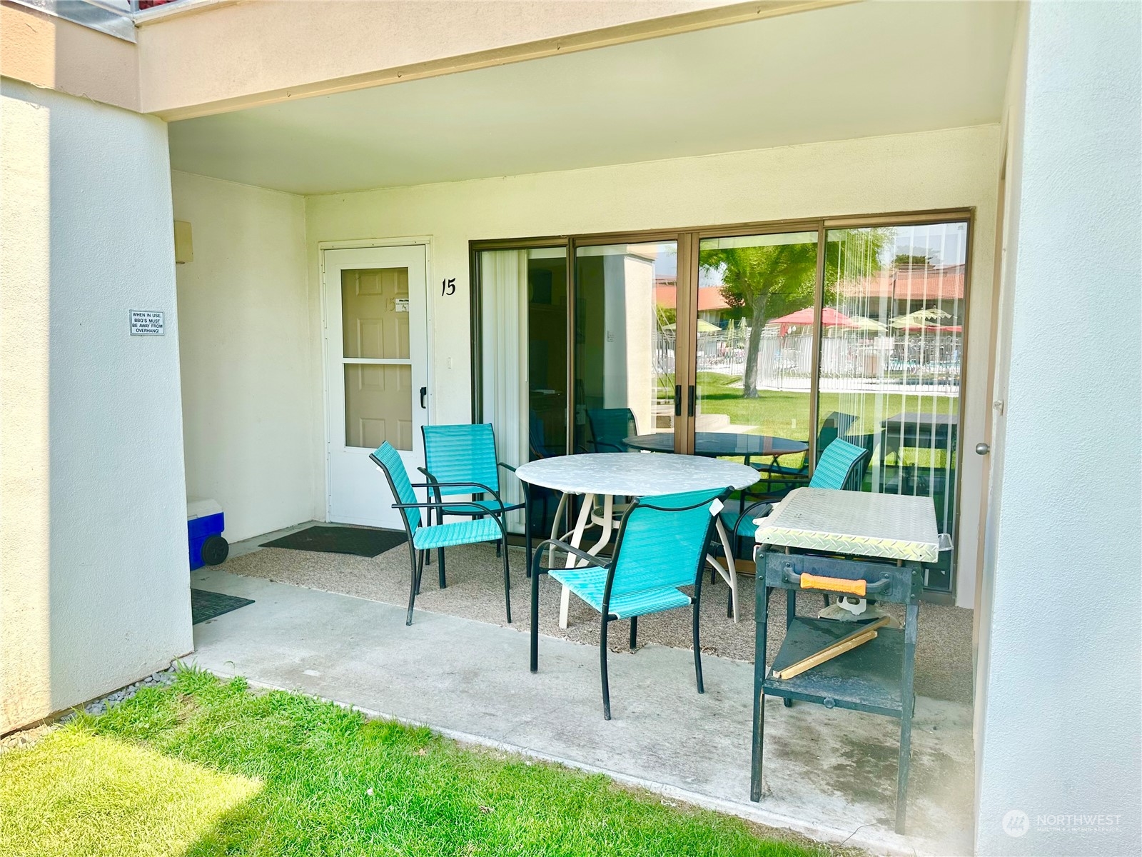 a view of an outdoor space with furniture and a backyard