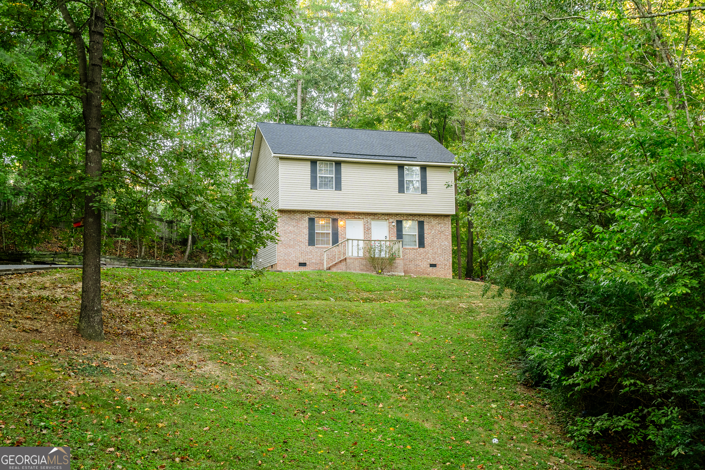 a front view of a house with a yard