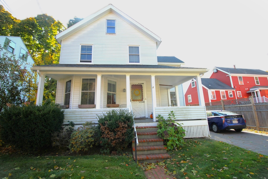 a front view of house with yard and car parked