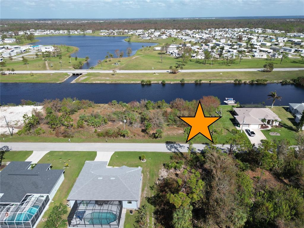 an aerial view of a building with a lake