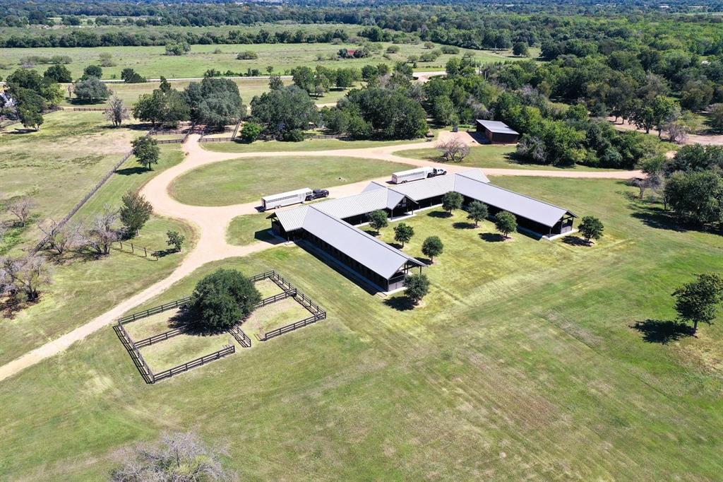 an aerial view of a house with a big yard