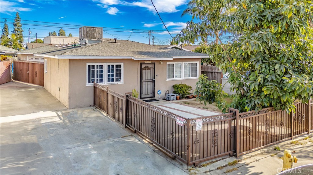 a view of a house with wooden fence