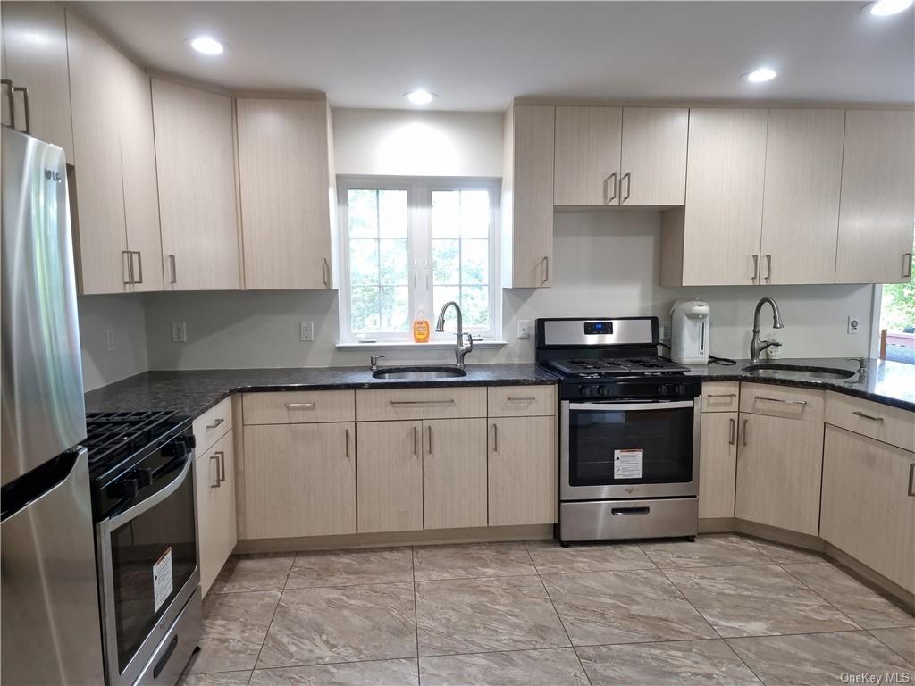 a kitchen with a sink stove top oven and cabinets