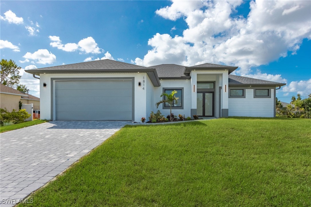 a front view of a house with a yard and garage