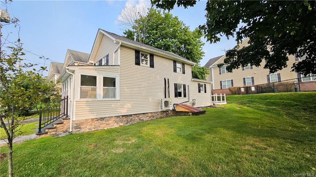 a view of a house with a backyard