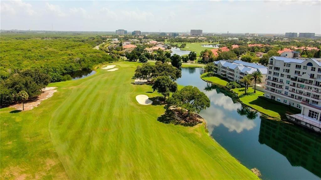 an aerial view of residential houses with outdoor space and swimming pool