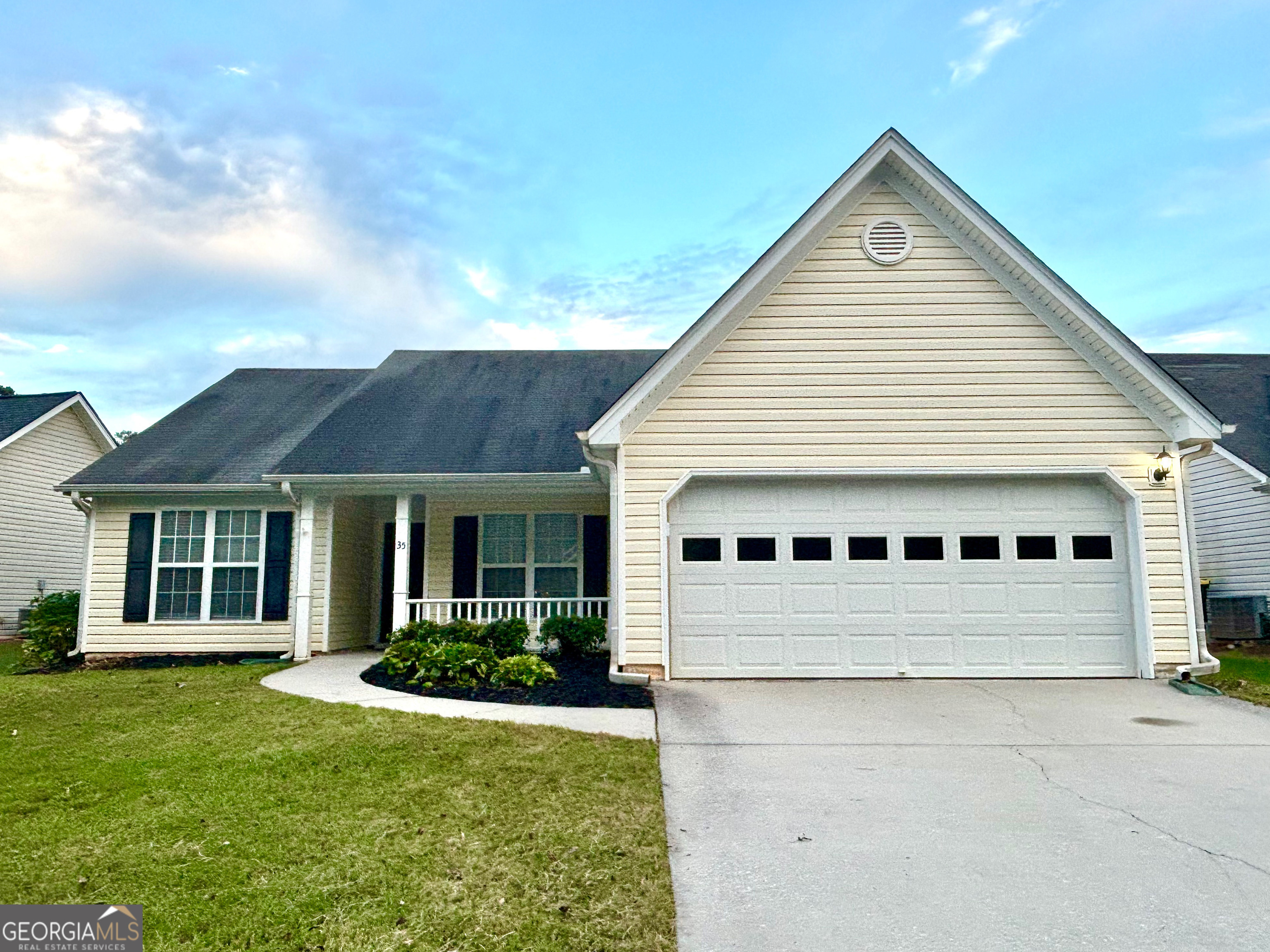 a view of house with a yard