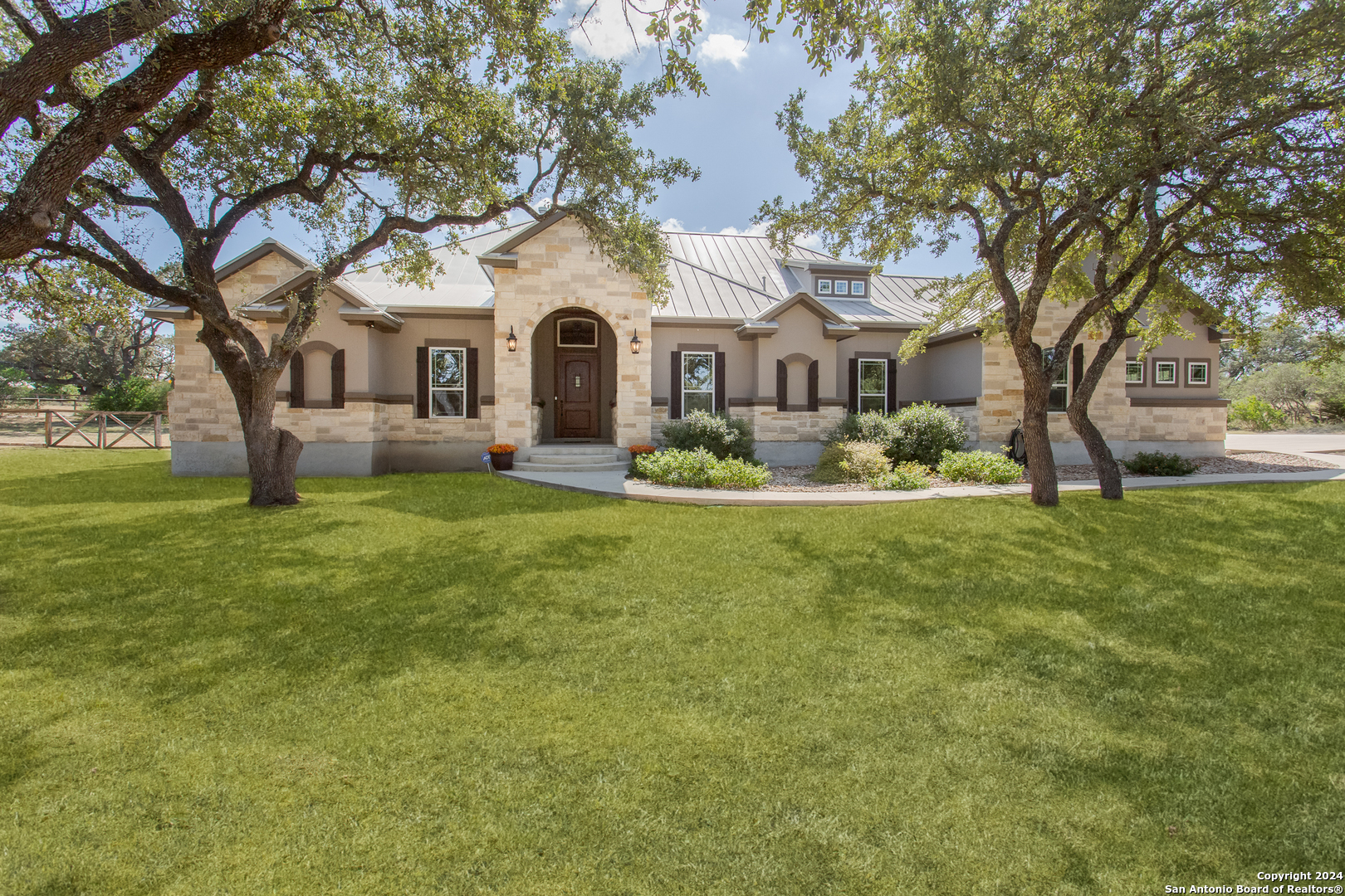 a front view of house with yard and green space