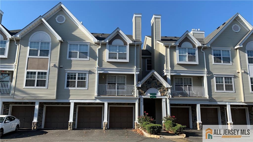 a front view of a residential apartment building with a yard