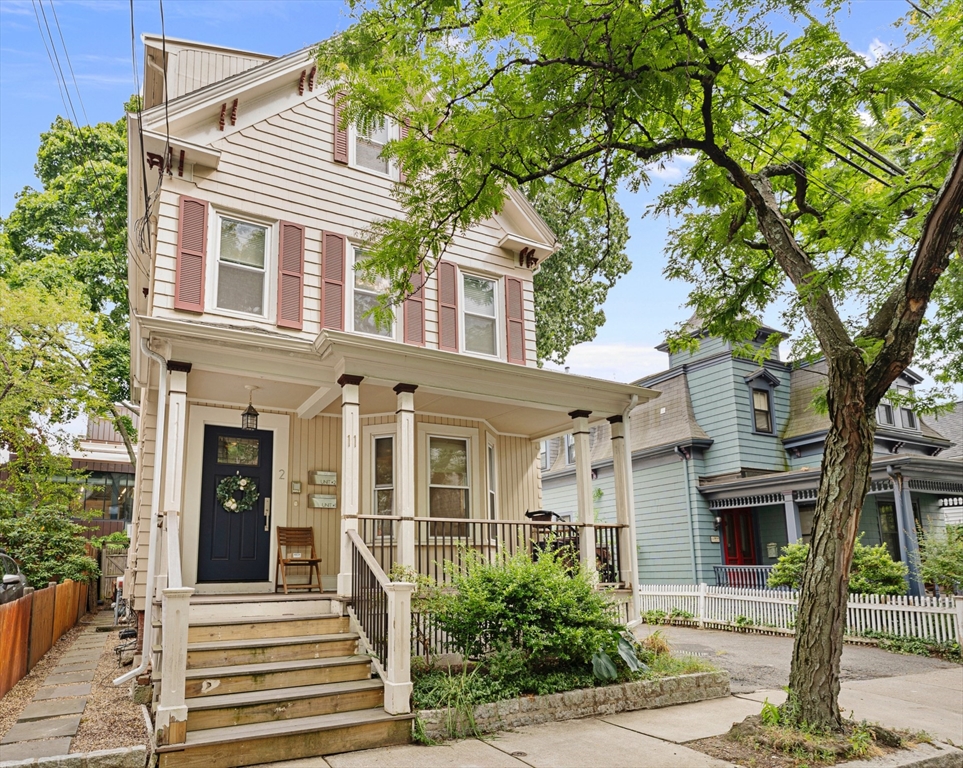 front view of a house with a tree