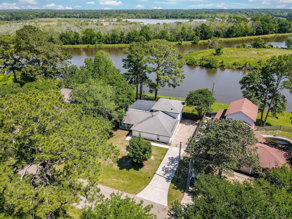 an aerial view of a house with a yard and lake view