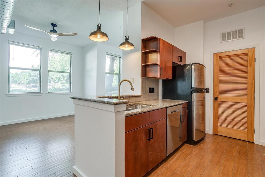 a kitchen with stainless steel appliances granite countertop a sink and a stove