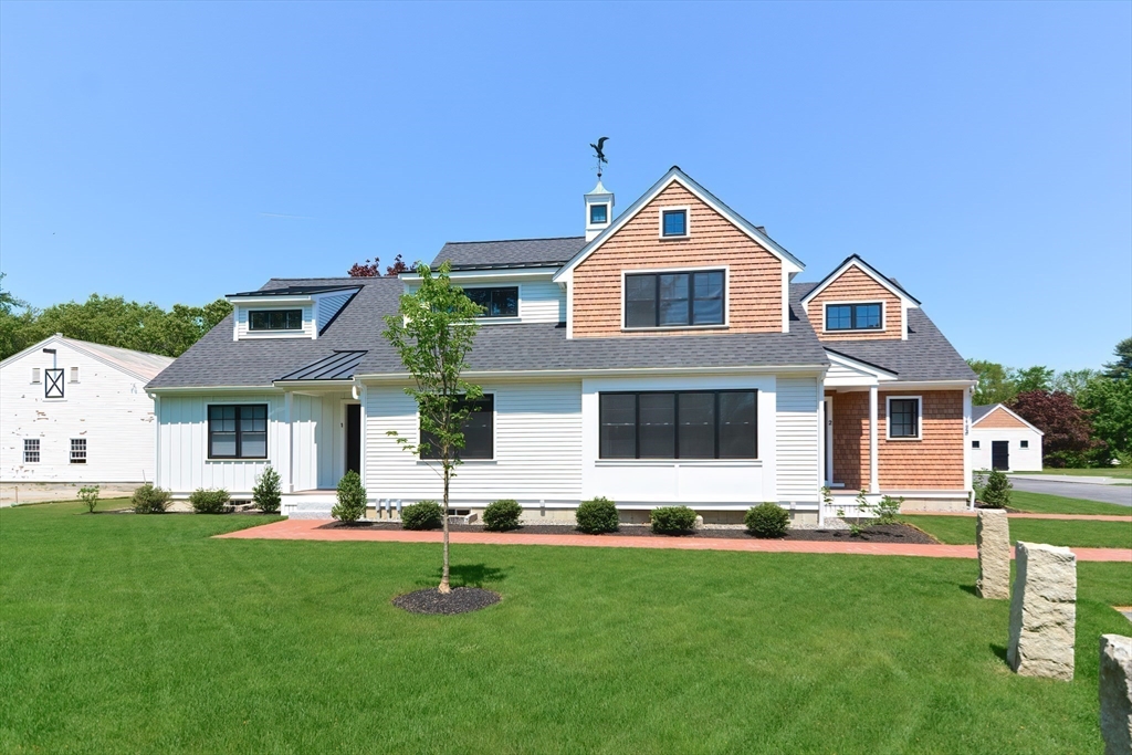 a front view of house with yard and green space