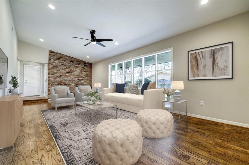 Beautiful wood floors and large windows in the living room *this photo is virtually staged*