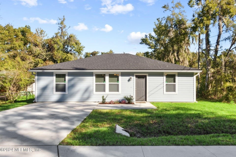 a front view of house with yard and green space