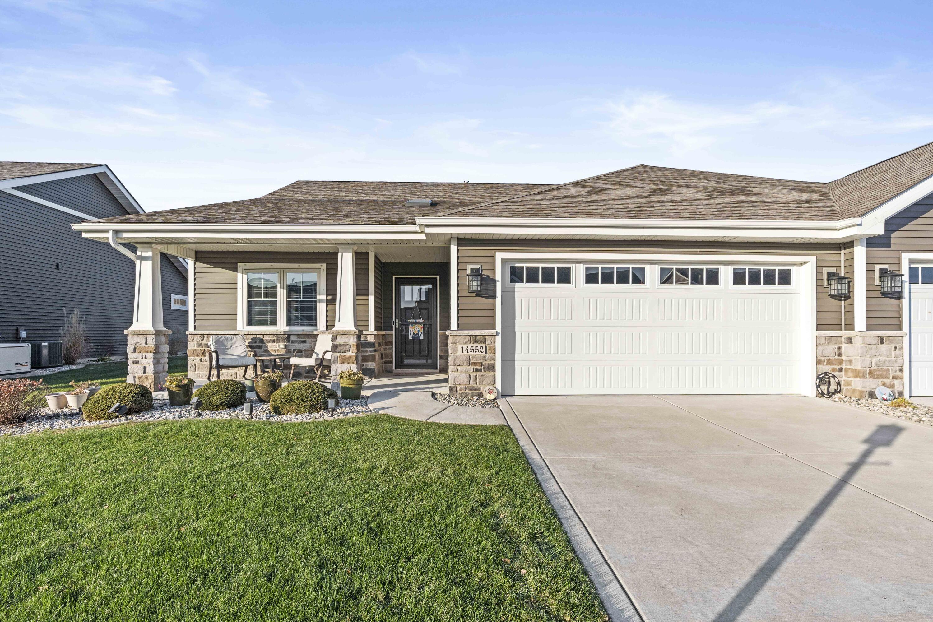 a front view of a house with patio and yard