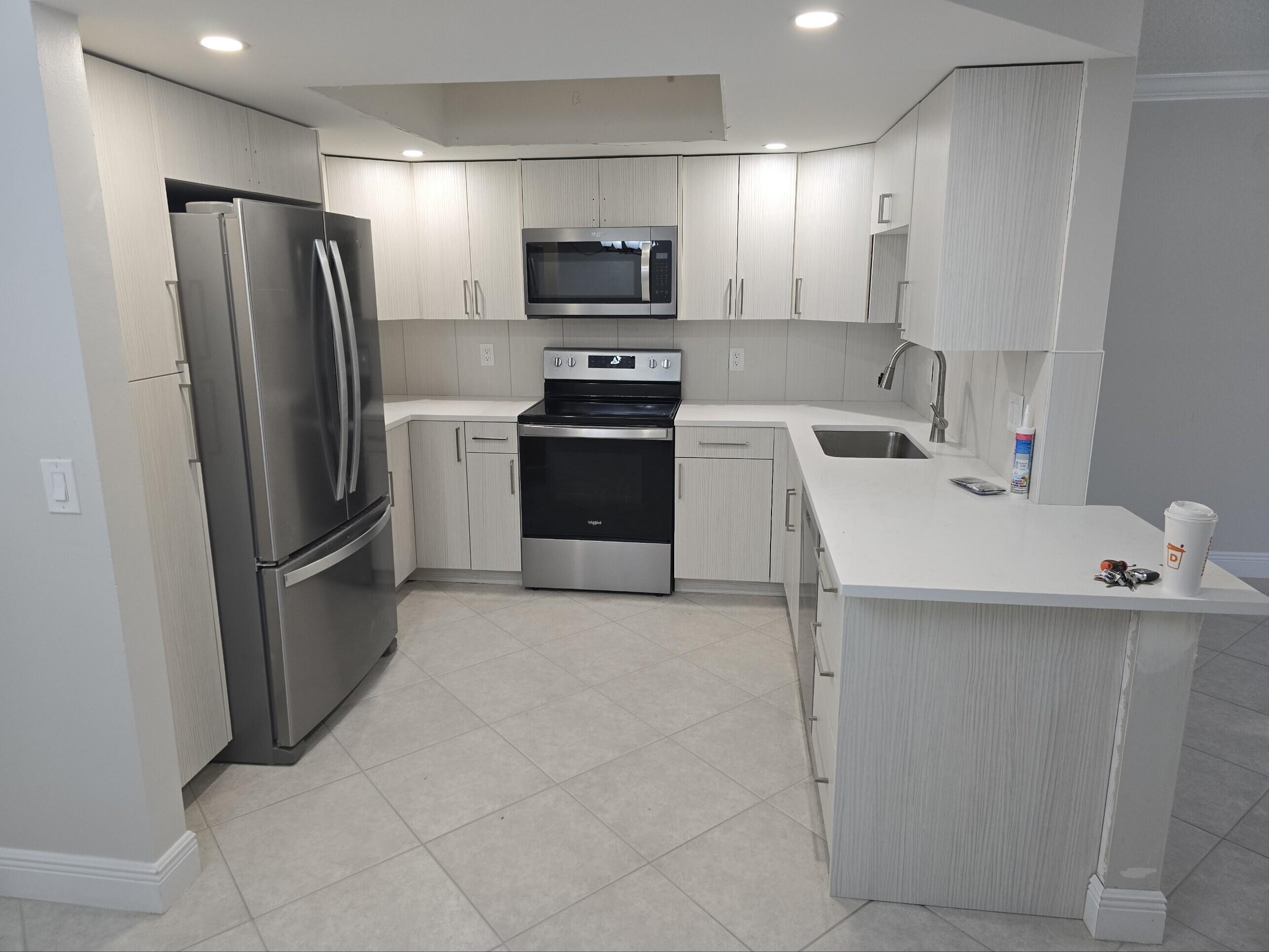 a kitchen that has a refrigerator and a sink