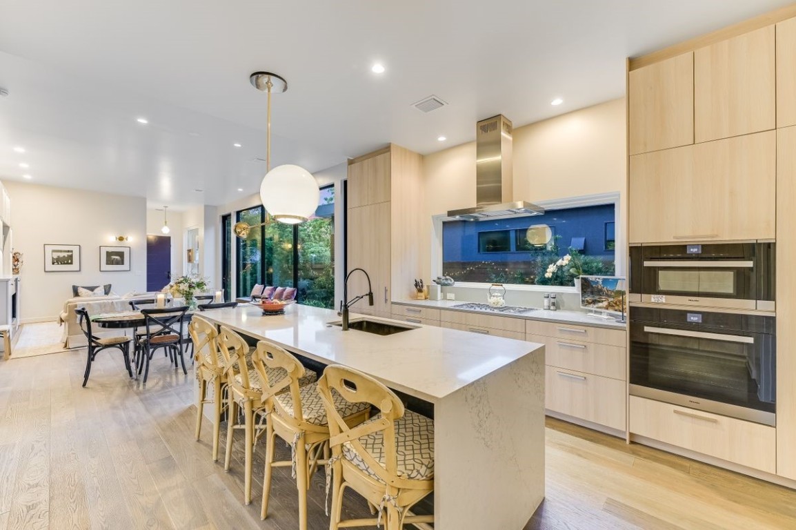 a large kitchen with a table and chairs