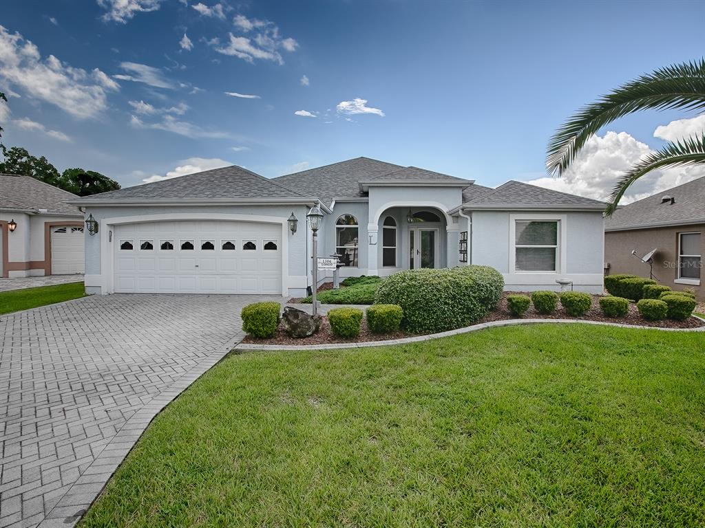 a front view of a house with a yard and garage