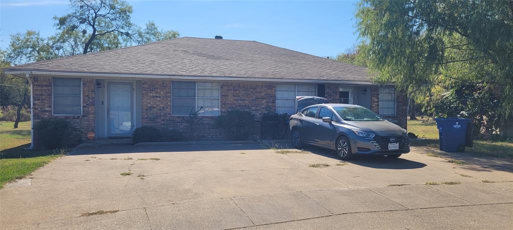 a front view of a house with parking space