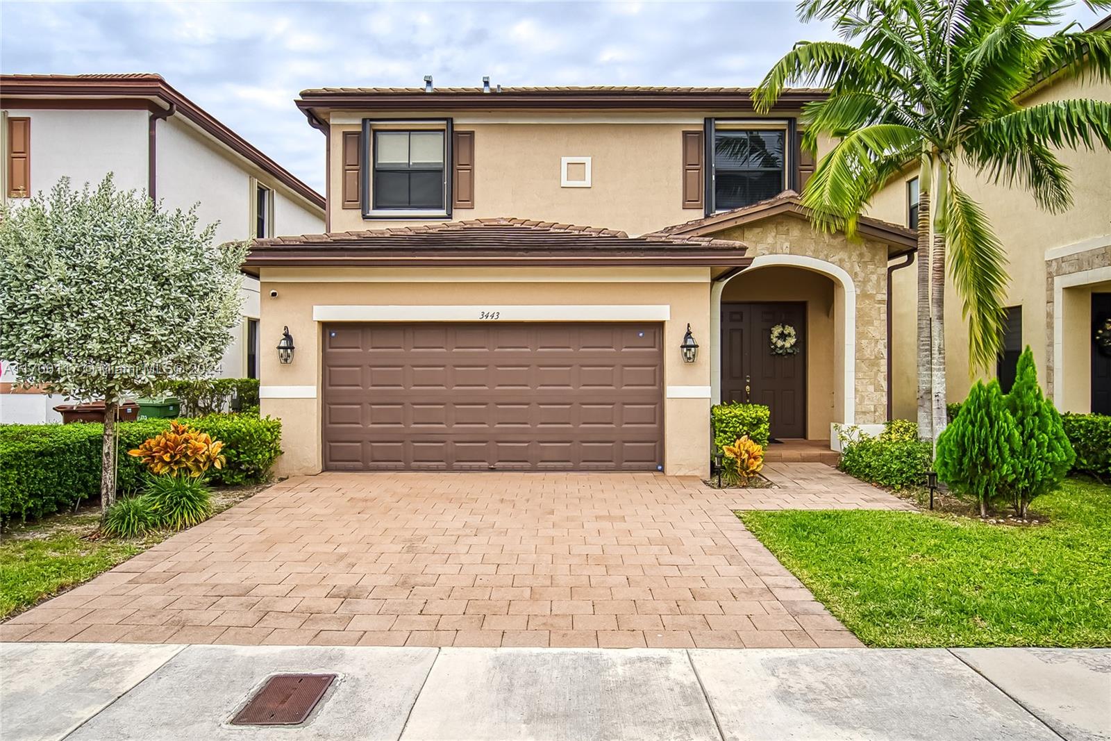 a front view of a house with a garden