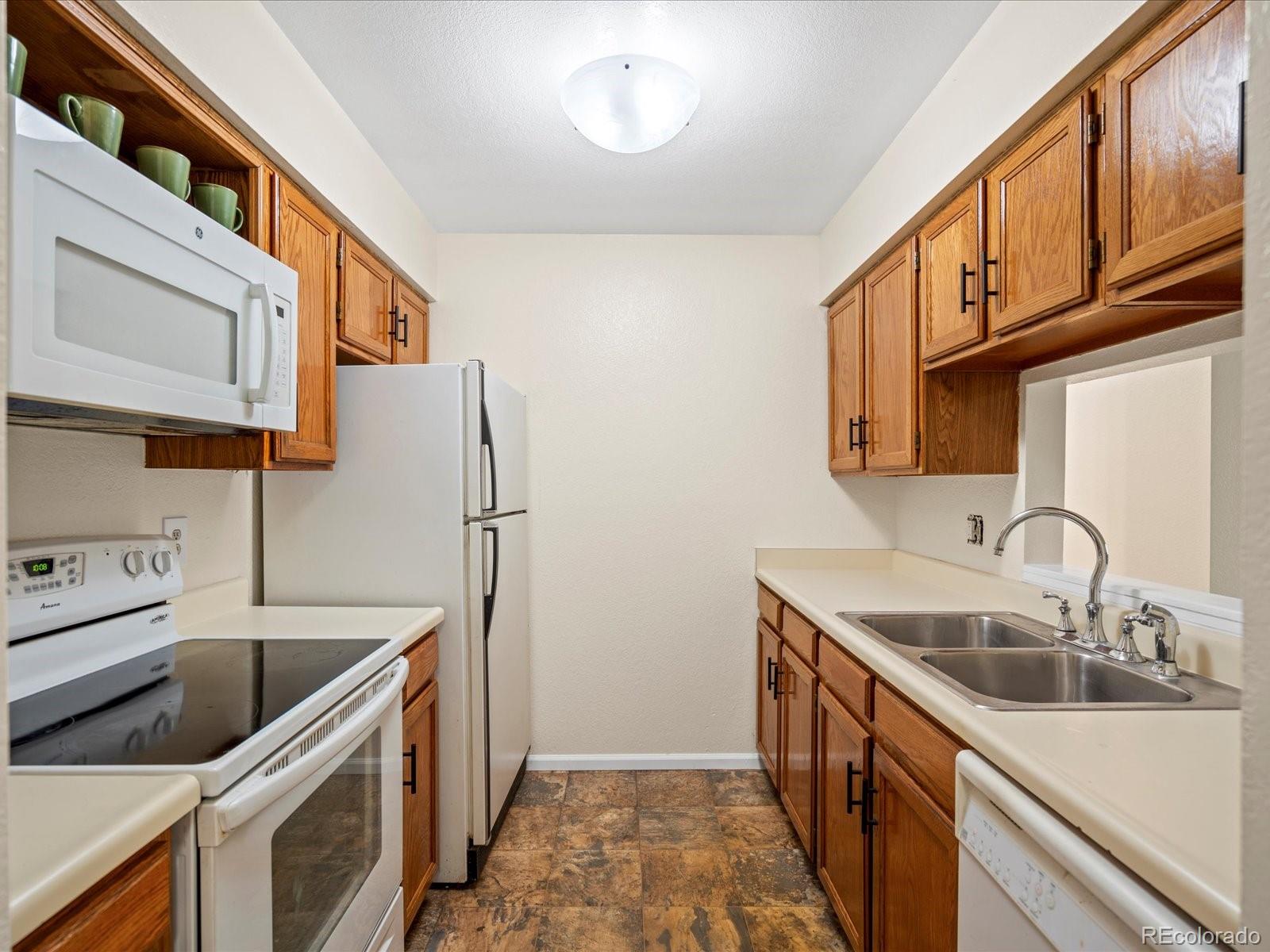 a kitchen that has a sink and a stove