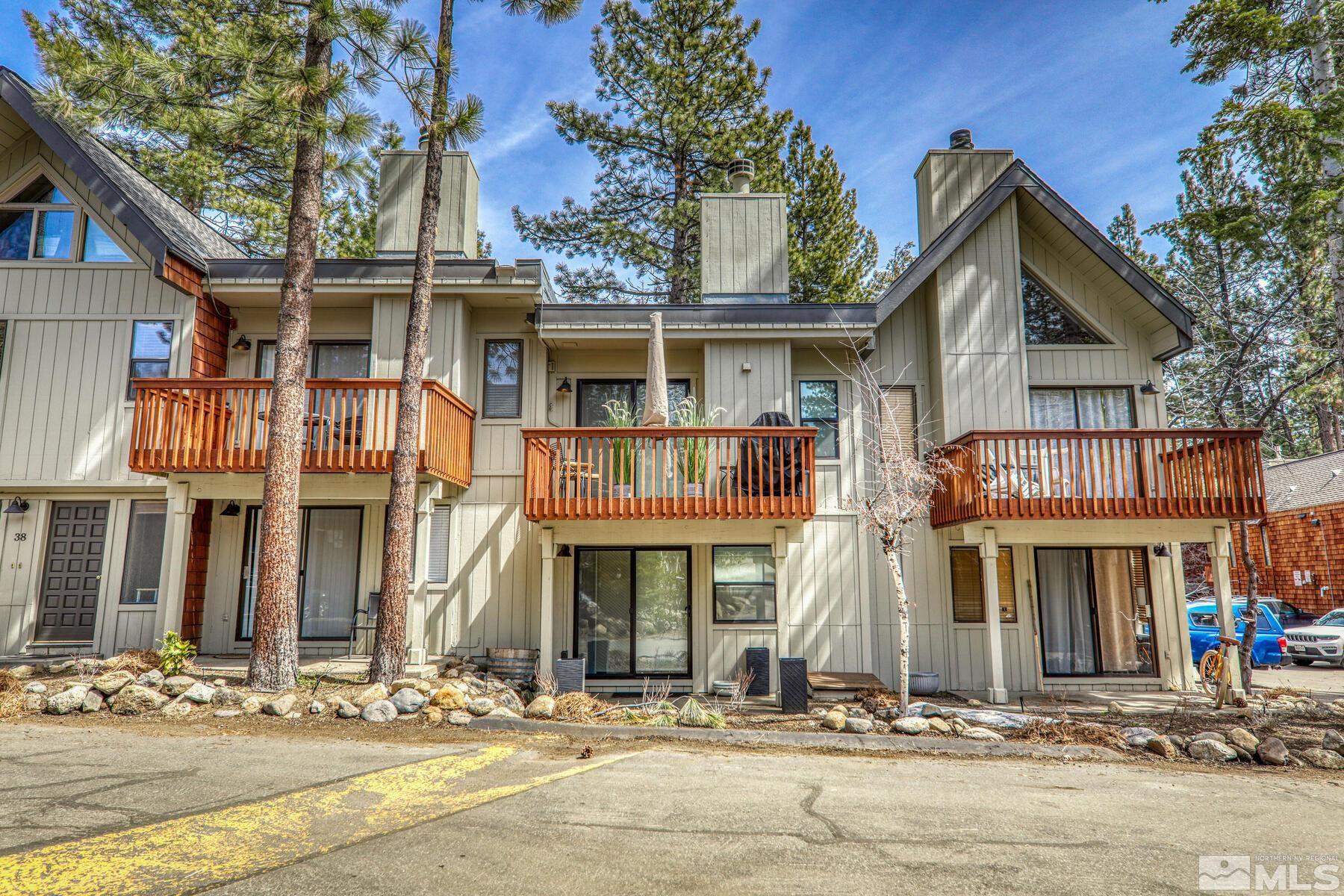 a front view of a residential apartment building with a yard