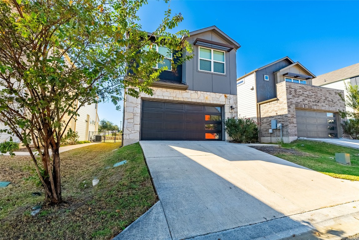 a front view of a house with a yard and garage