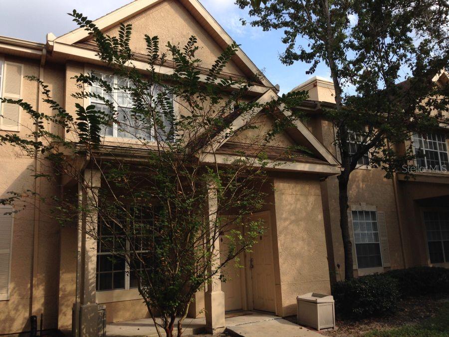 a view of a house with a tree