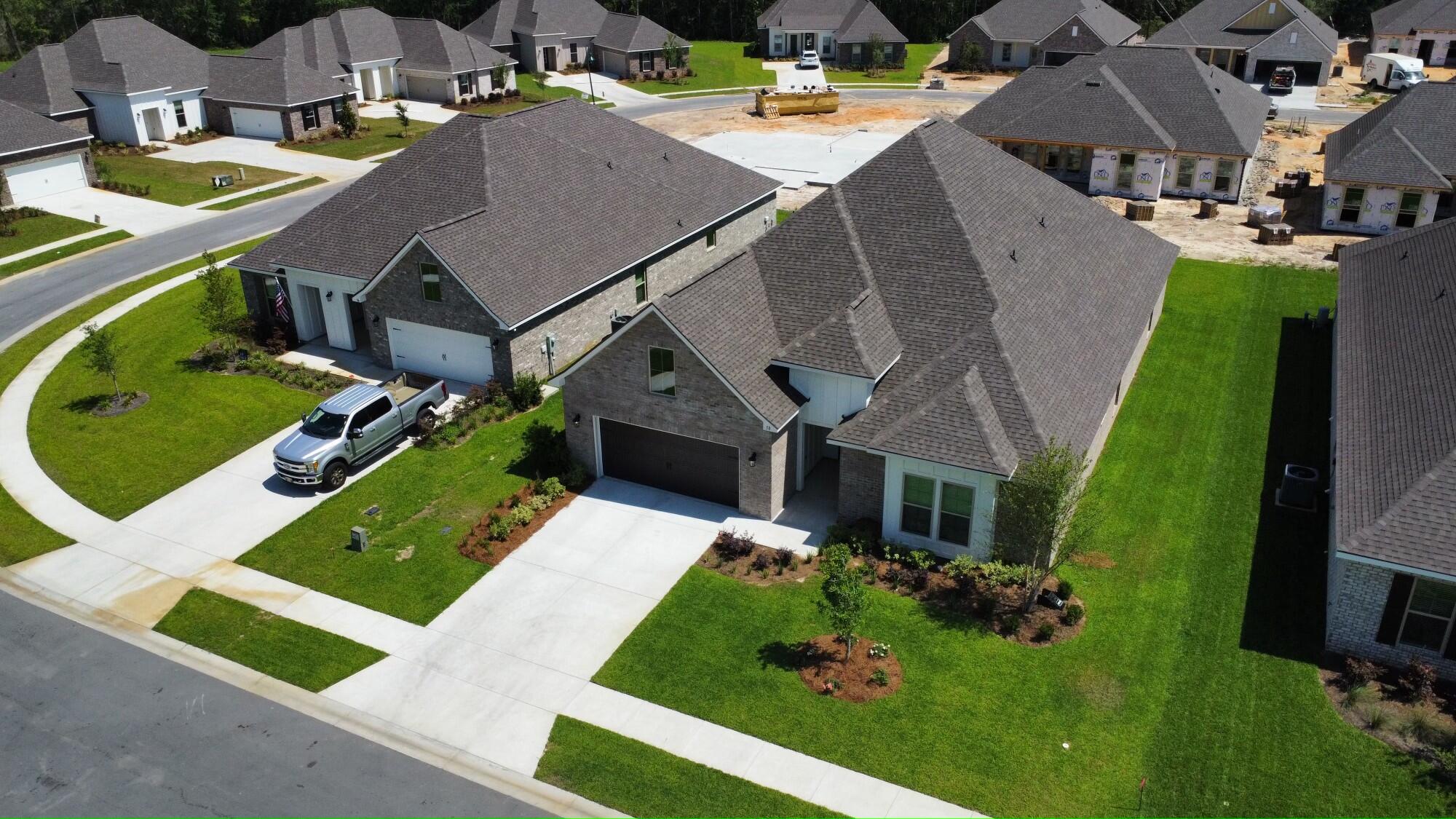 an aerial view of a house with garden space and street view