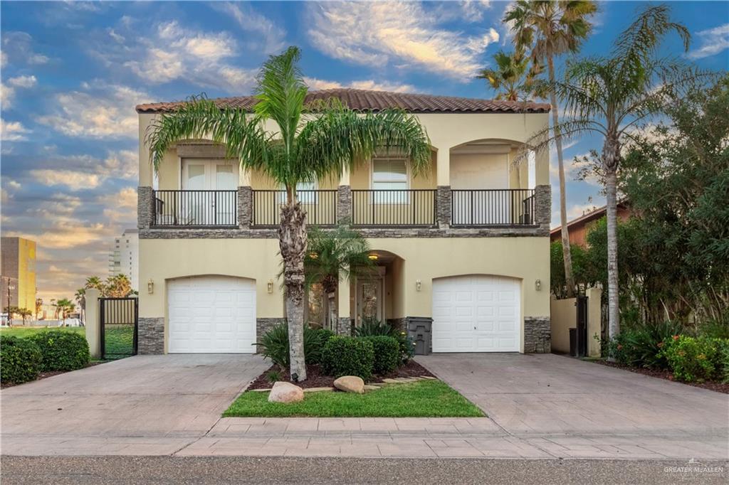 Mediterranean / spanish home with a garage and a balcony