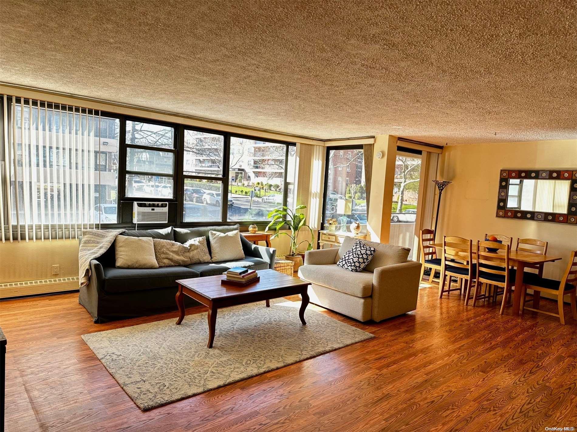 a living room with furniture and a floor to ceiling window