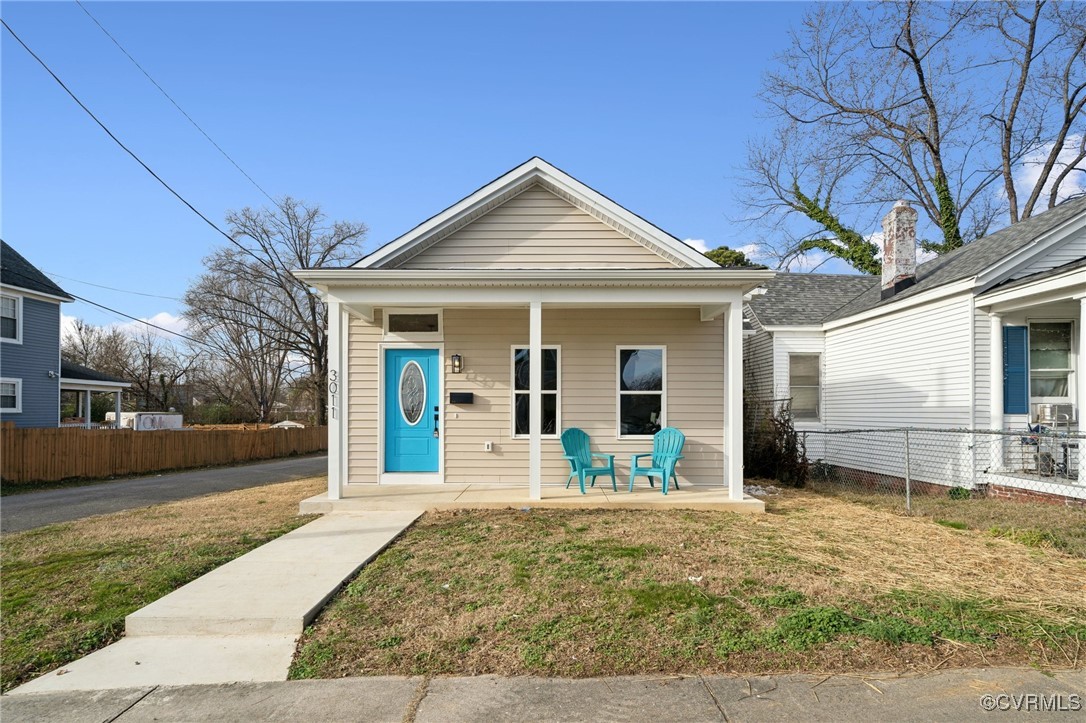 Bungalow with a porch and a front yard