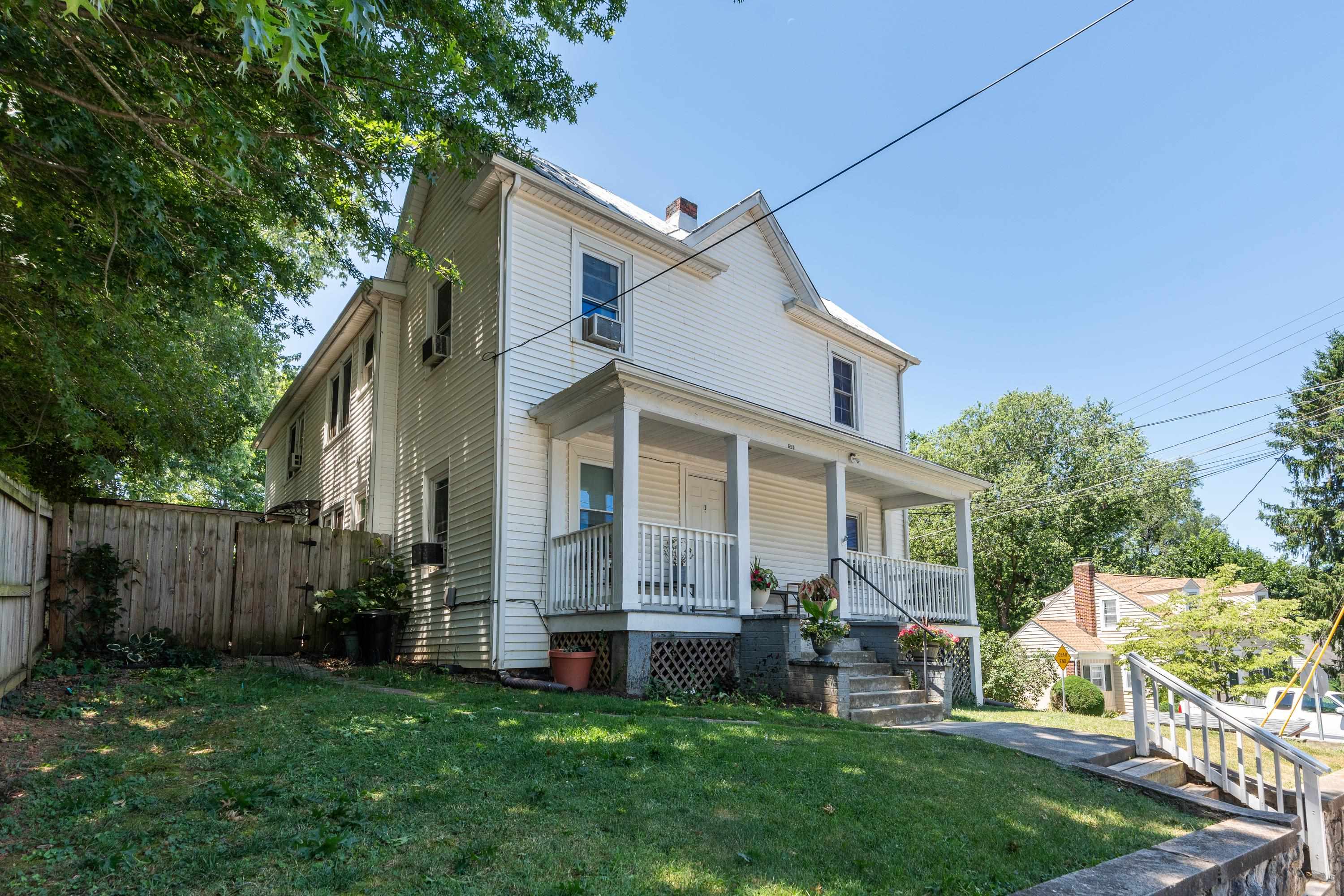 a view of house with a yard