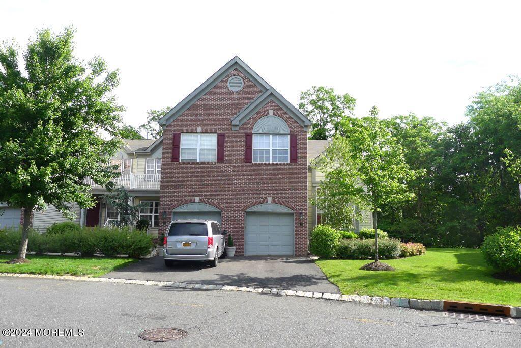 a car parked in front of a house with a yard