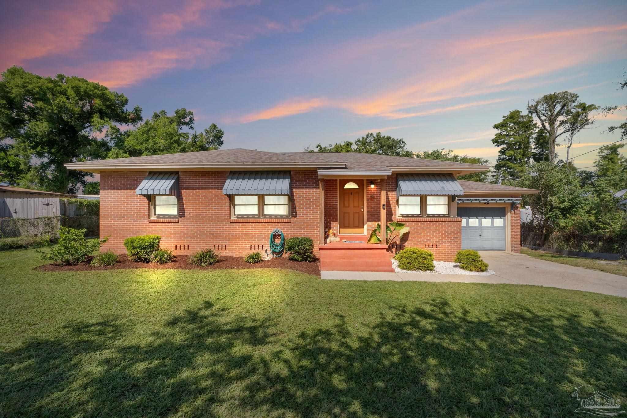 a front view of a house with patio and yard