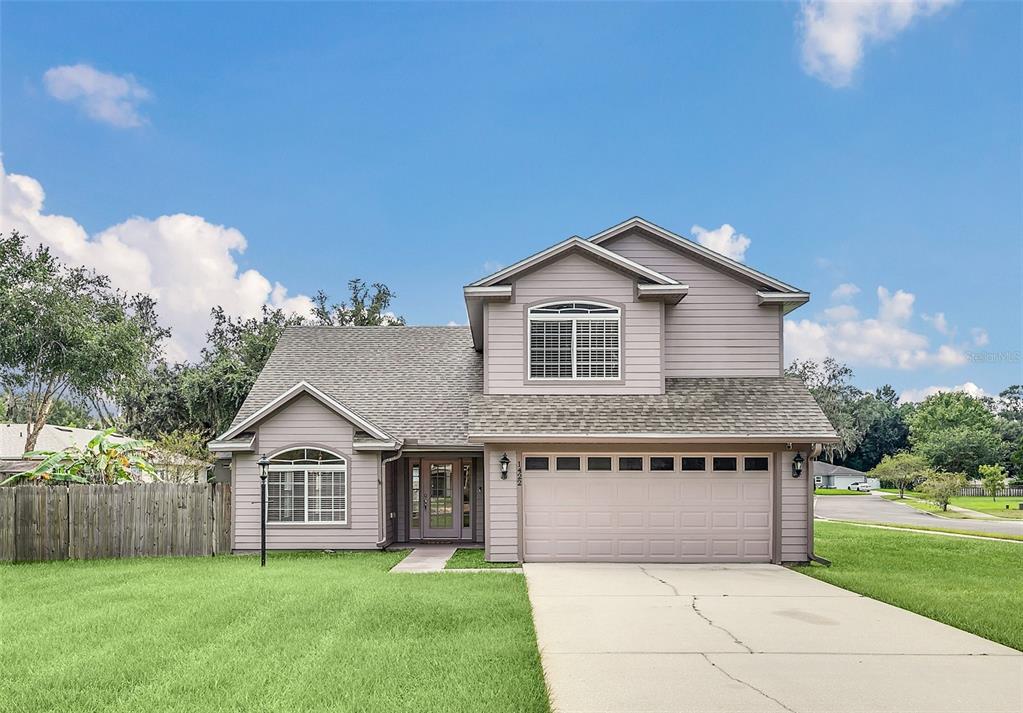 a front view of a house with a yard and garage