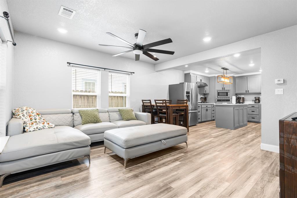 a living room with furniture and kitchen view