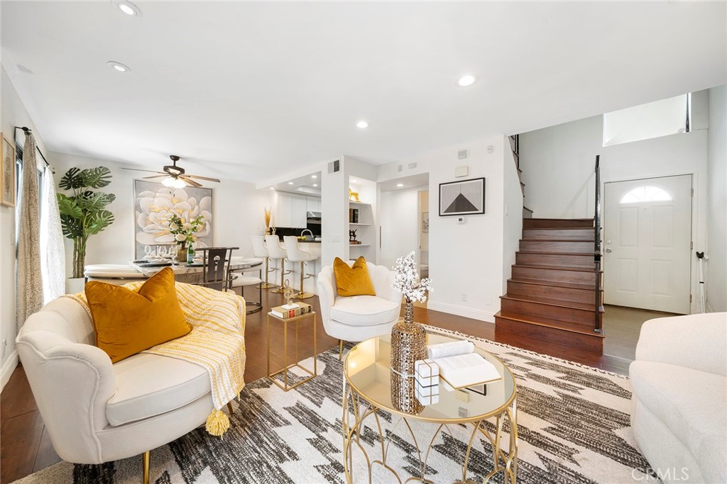 a living room with furniture and wooden floor