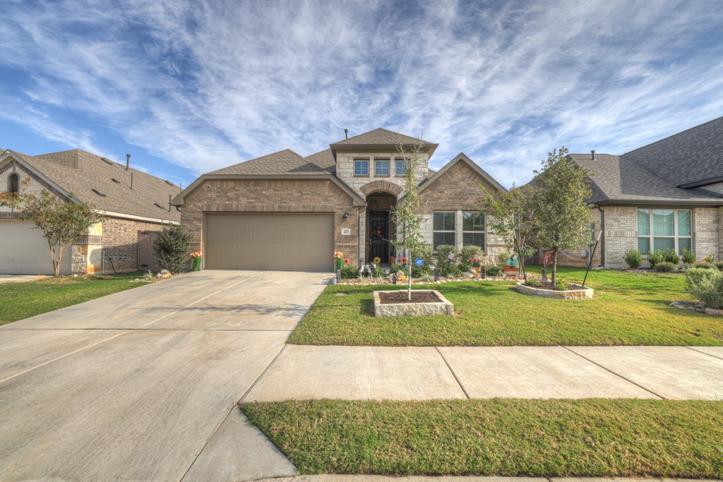 a front view of a house with a yard