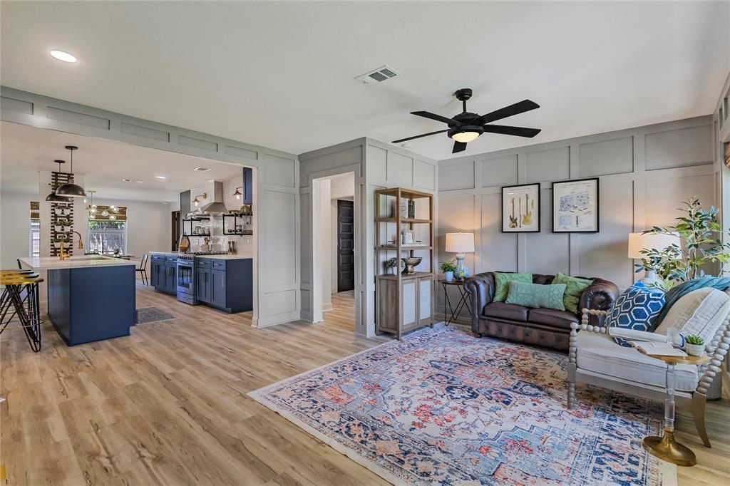 a living room with furniture and a wooden floor