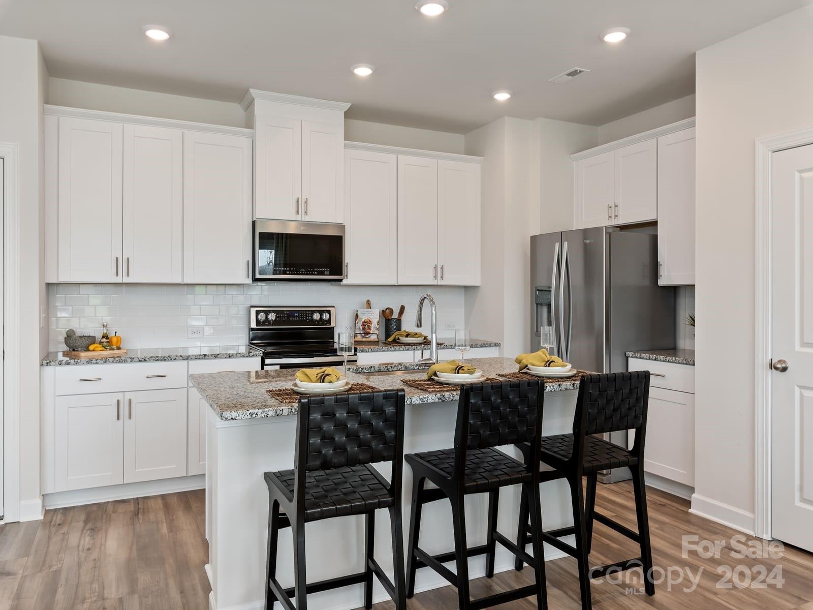 a kitchen with a dining table and chairs