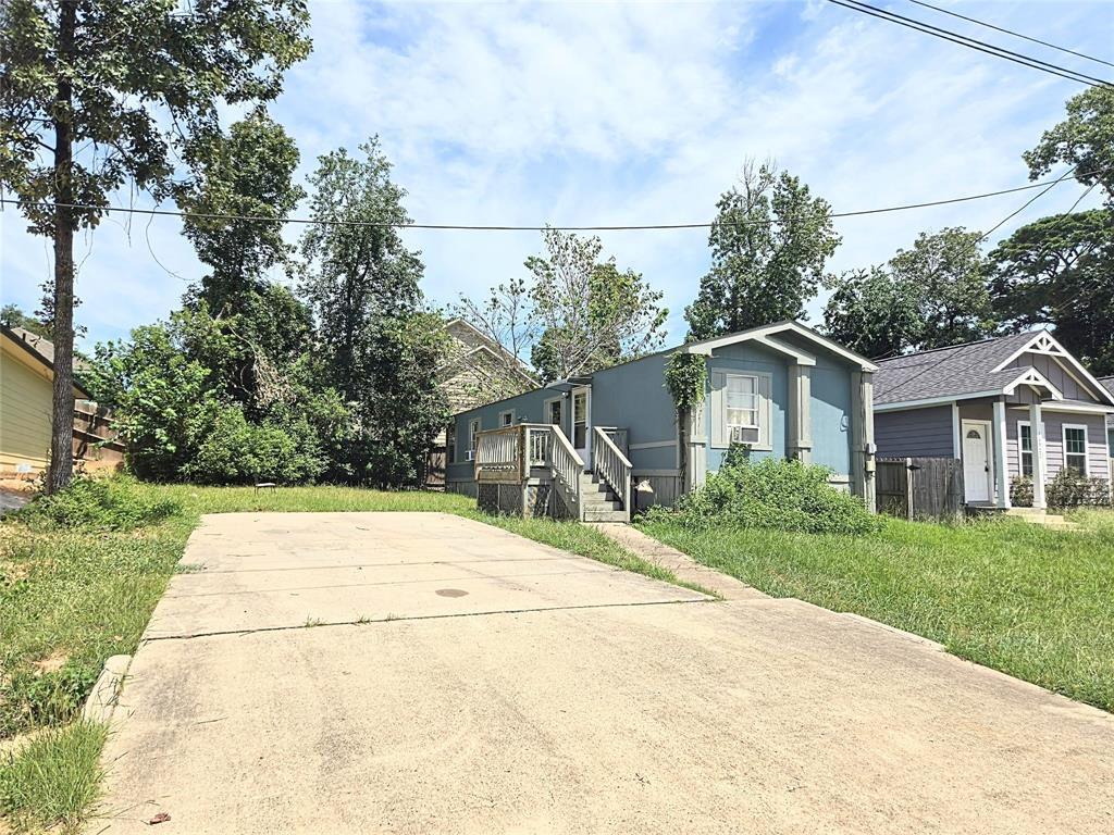 a front view of a house with a yard and trees